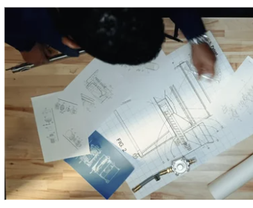 Product development — hands reviewing technical drawings